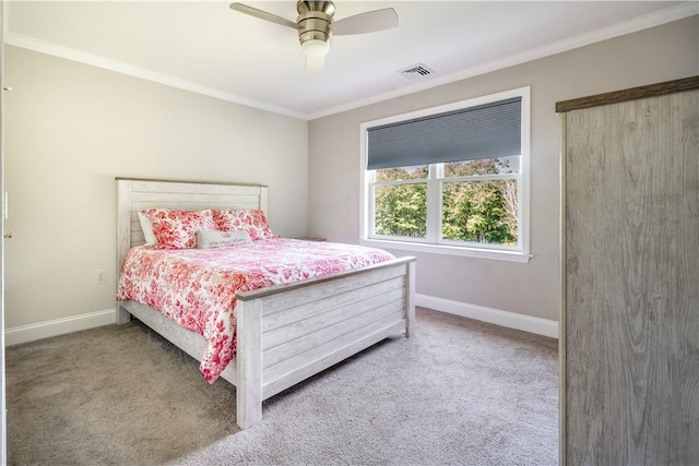 carpeted bedroom featuring crown molding and ceiling fan