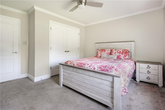 carpeted bedroom featuring crown molding, ceiling fan, and a closet