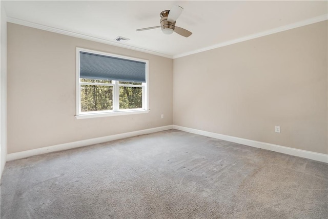 carpeted spare room with crown molding and ceiling fan