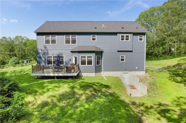 rear view of property with a yard and a deck