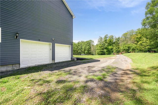 garage featuring a lawn