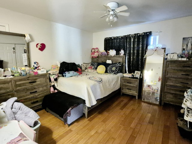 bedroom with ceiling fan and hardwood / wood-style floors