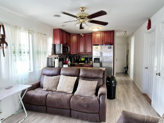 living room featuring ceiling fan and light hardwood / wood-style floors