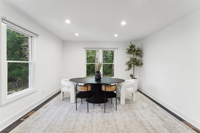 dining area featuring recessed lighting, plenty of natural light, baseboards, and wood finished floors