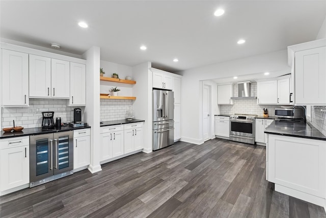 kitchen featuring wine cooler, open shelves, stainless steel appliances, dark countertops, and wall chimney exhaust hood