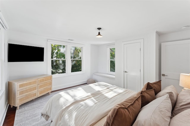 bedroom with wood finished floors and baseboards