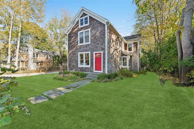 shingle-style home with a front lawn