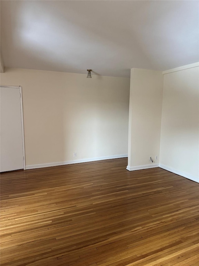 spare room with wood-type flooring