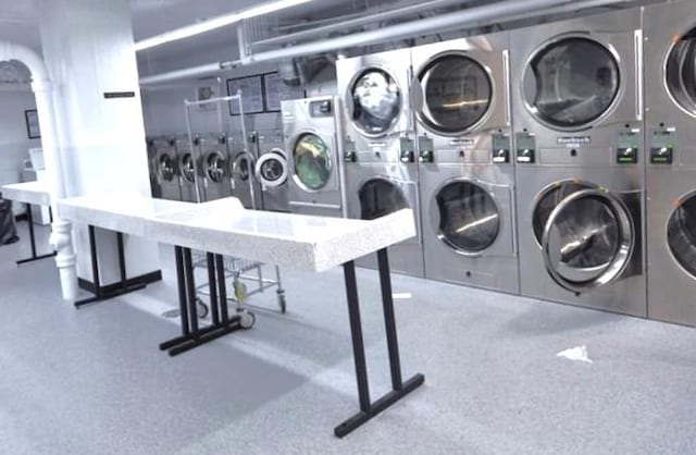 laundry area with stacked washer and clothes dryer