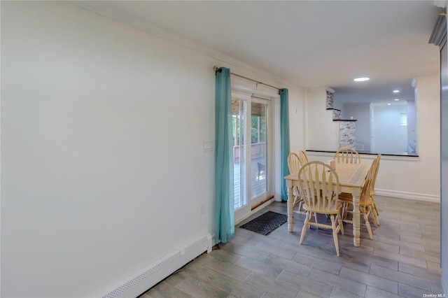 dining room with a baseboard radiator and ornamental molding