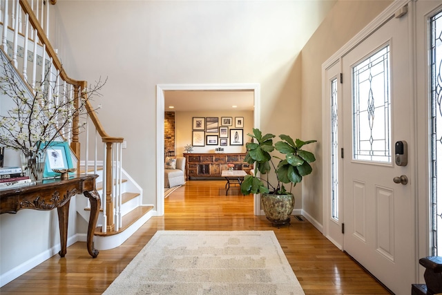 entryway with hardwood / wood-style flooring and a high ceiling