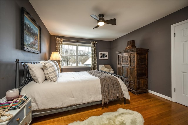 bedroom with dark wood-type flooring and ceiling fan