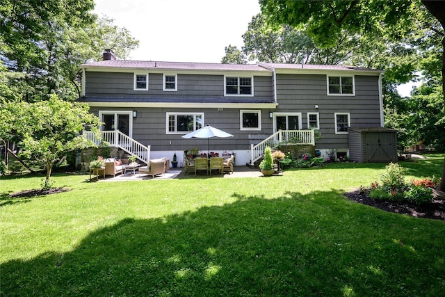 rear view of property featuring a lawn and a patio