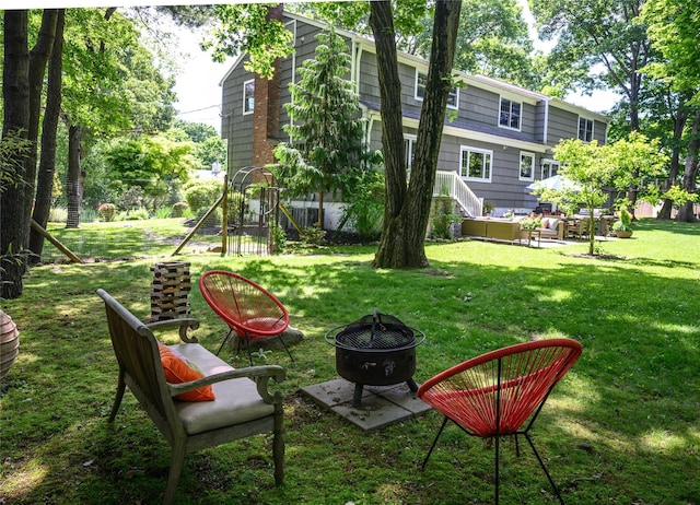 view of yard featuring an outdoor fire pit and a playground