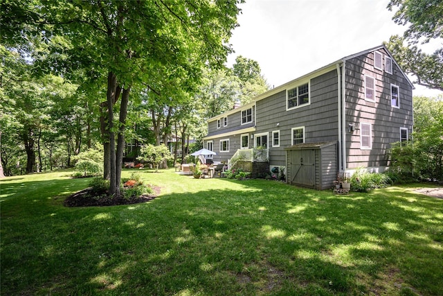 rear view of property featuring a lawn