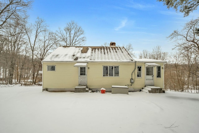 view of snow covered rear of property