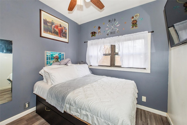 bedroom with ceiling fan and dark hardwood / wood-style floors