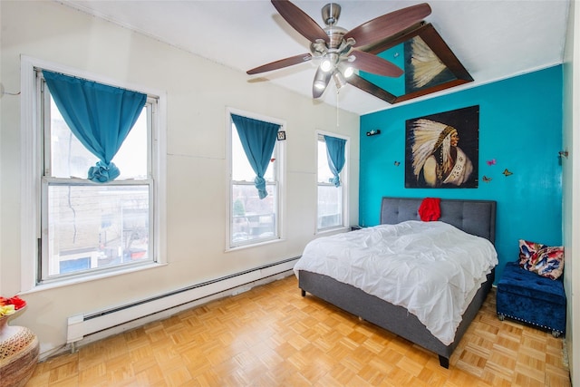 bedroom with multiple windows, a baseboard radiator, light parquet flooring, and ceiling fan