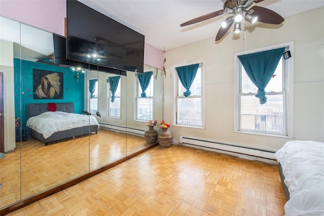 bedroom featuring parquet floors, ceiling fan, and baseboard heating