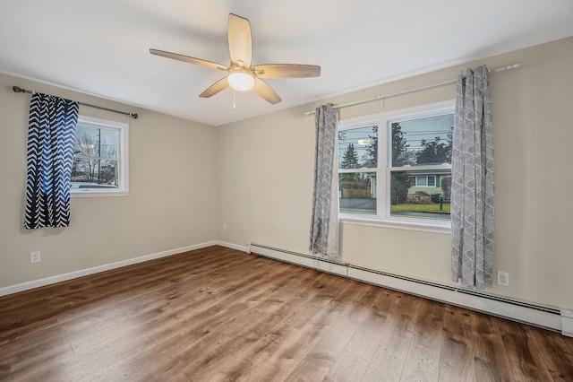 empty room with baseboard heating, ceiling fan, and hardwood / wood-style floors