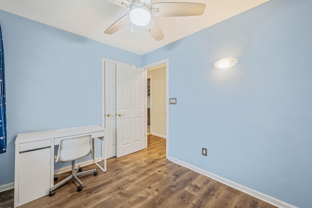 home office featuring wood-type flooring and ceiling fan