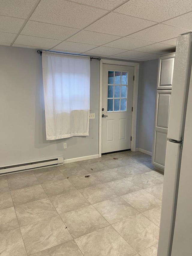 doorway with a baseboard radiator and a paneled ceiling