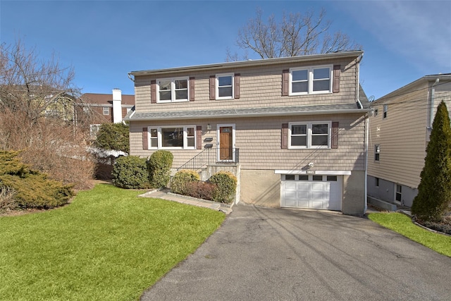 view of front property with a garage and a front yard