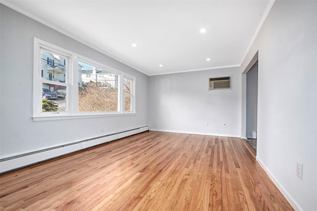 spare room with crown molding, a baseboard radiator, light hardwood / wood-style floors, and a wall mounted AC