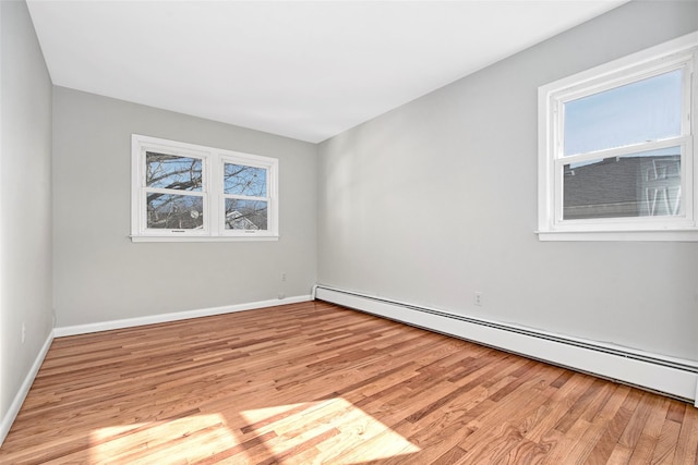 unfurnished room featuring light hardwood / wood-style flooring and baseboard heating