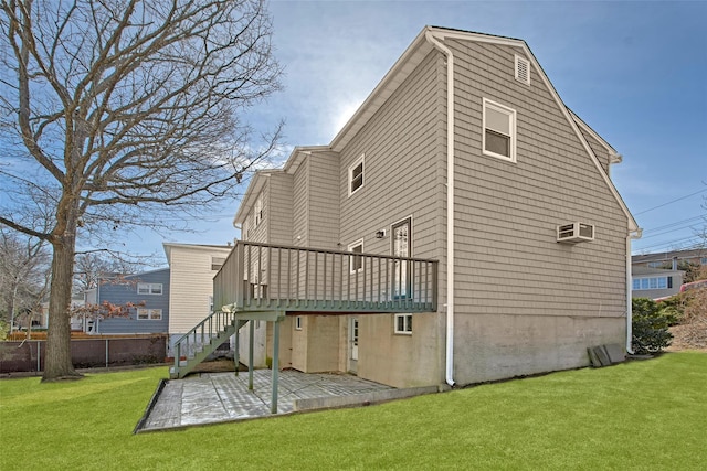 back of property with a lawn, a wall unit AC, and a patio