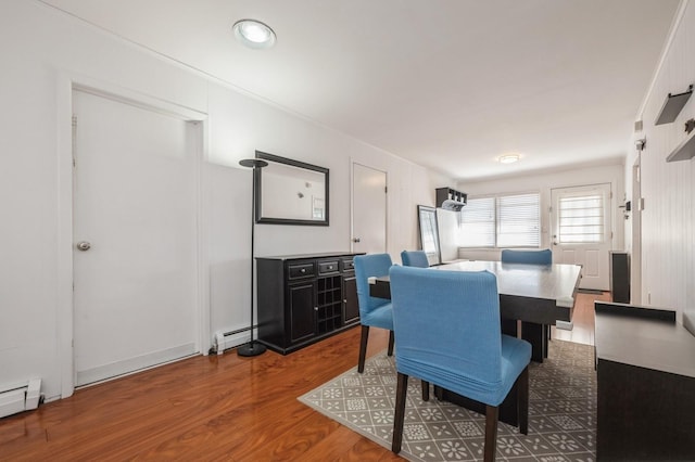 dining room with hardwood / wood-style floors and a baseboard radiator