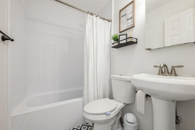 bathroom featuring shower / bathtub combination with curtain and toilet