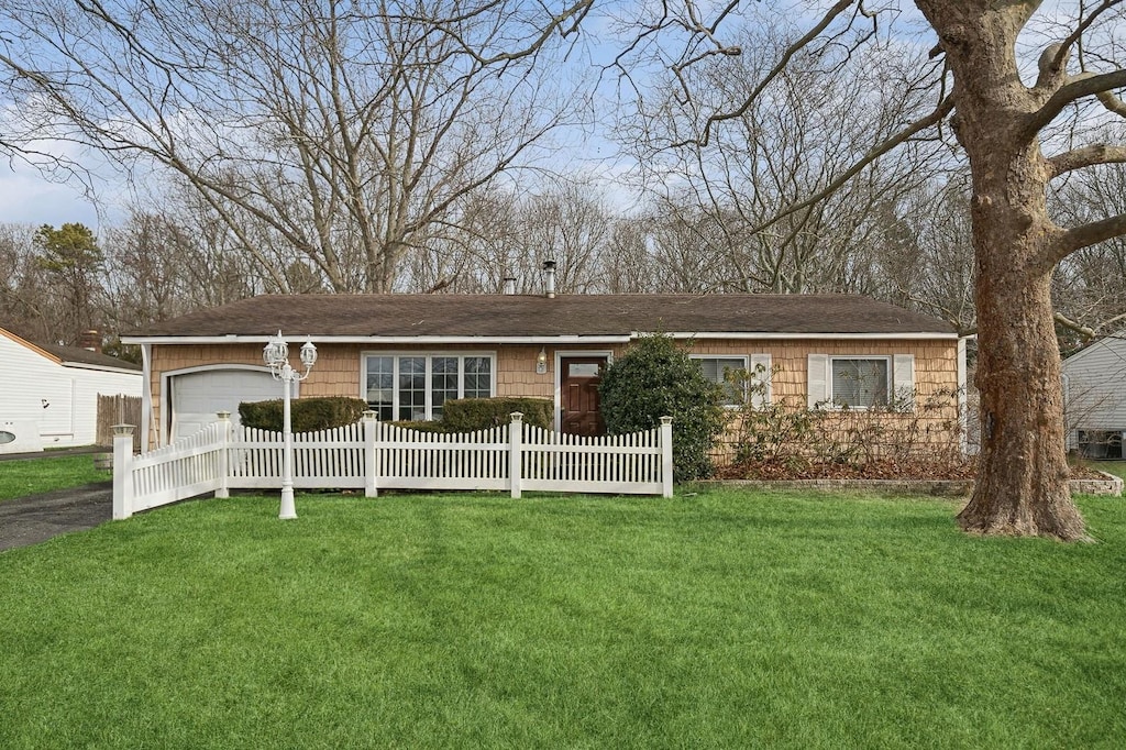 single story home with a garage and a front yard