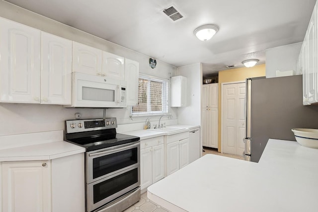 kitchen with white cabinetry, sink, and appliances with stainless steel finishes