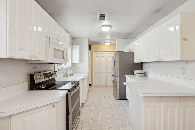 kitchen with white cabinetry, sink, and appliances with stainless steel finishes