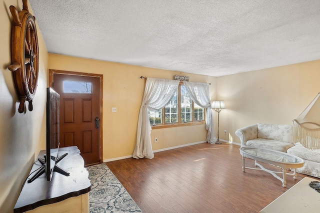 foyer with hardwood / wood-style flooring and a textured ceiling