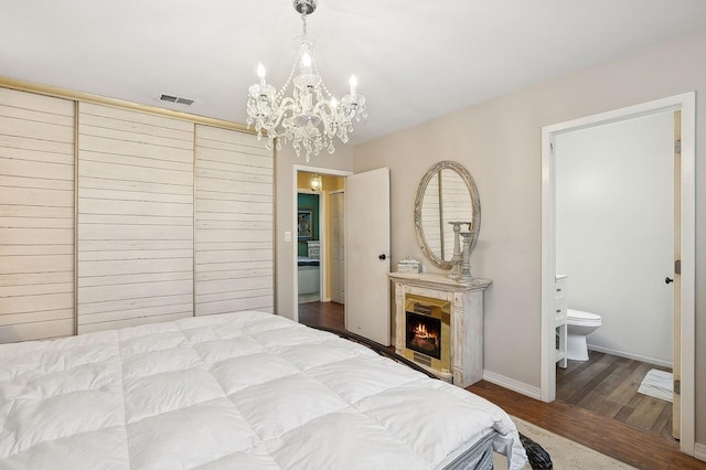 bedroom featuring connected bathroom and hardwood / wood-style floors