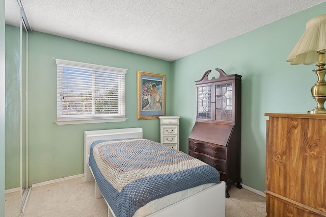 carpeted bedroom featuring a textured ceiling