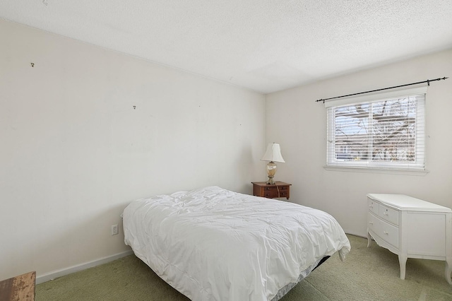 carpeted bedroom featuring a textured ceiling