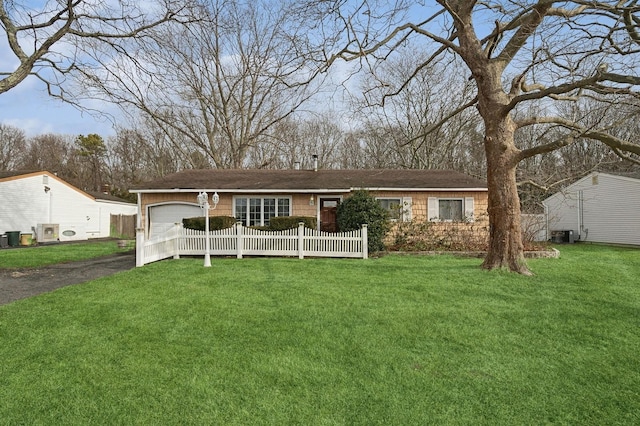 ranch-style home with a garage and a front yard