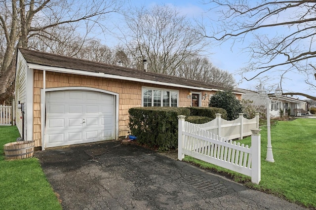 ranch-style house with a garage and a front lawn