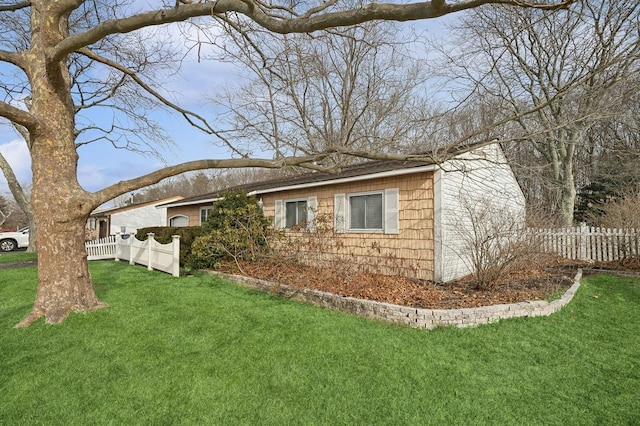 view of side of home featuring a lawn