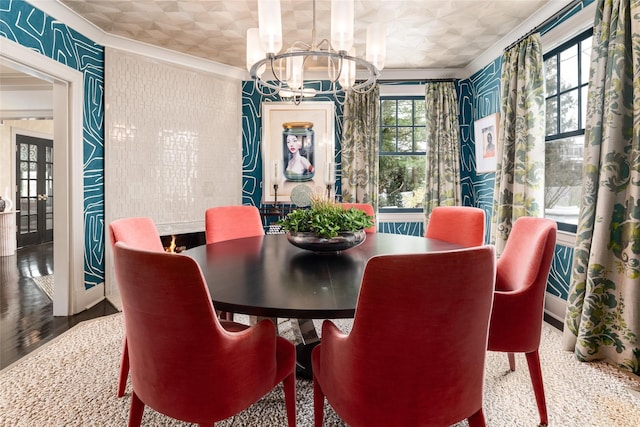 dining room with ornamental molding, wood-type flooring, a notable chandelier, and french doors