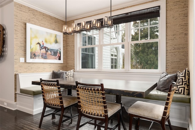 dining room featuring breakfast area, dark wood-type flooring, plenty of natural light, and ornamental molding