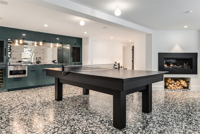 playroom featuring wine cooler and sink