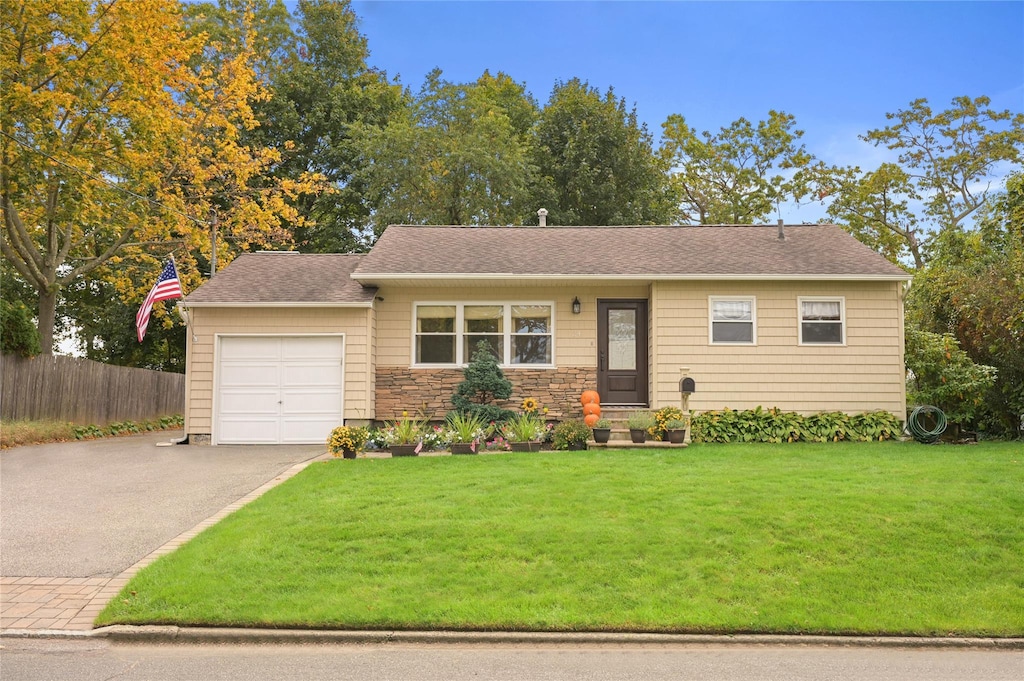 view of front of house with a garage and a front lawn