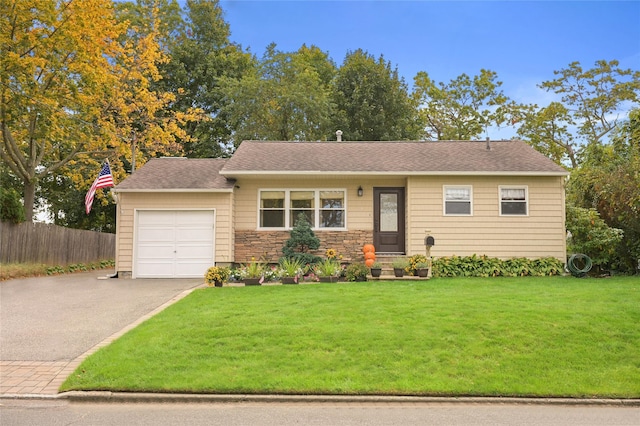 view of front of house with a garage and a front lawn