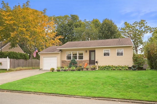 view of front of house with a garage and a front lawn