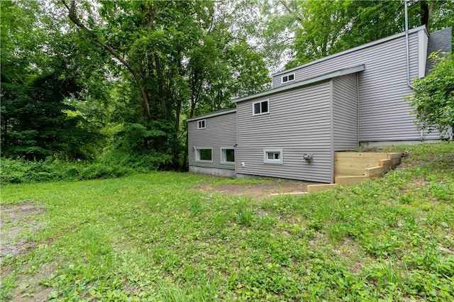 view of property exterior with a lawn