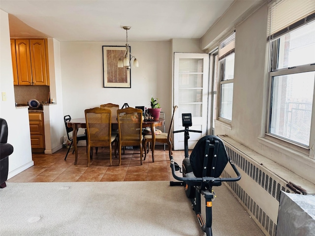 carpeted dining area with radiator